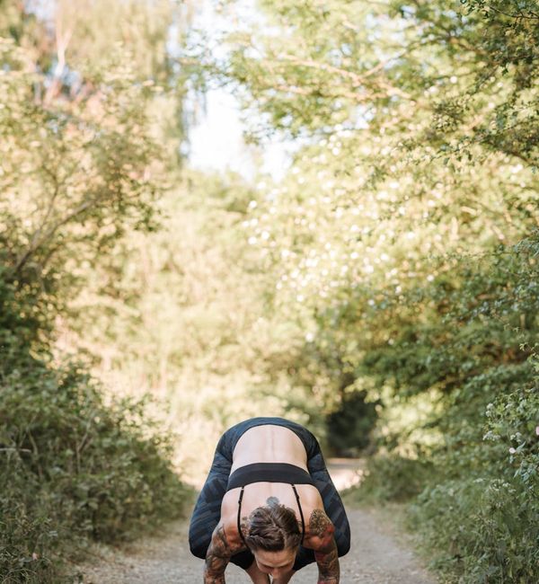 Woman performing a challenging balance yoga pose, showing strength.